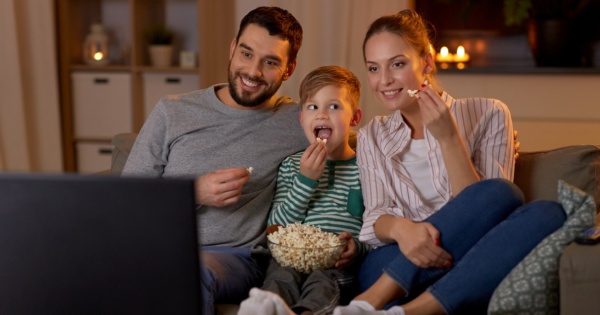 Happy family watching a movie in their warm, insulated cnservatory