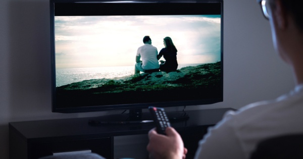 Man watching tv in his conservatory living room