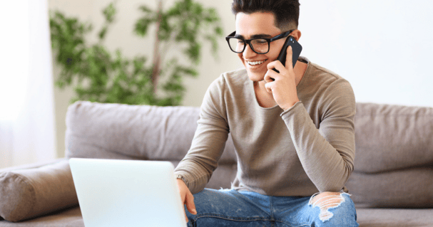 Man answering call in his conservatory office