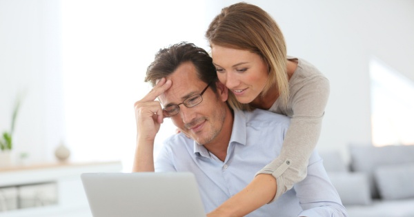 Couple checking a fixed price quote before converting their conservatory roof with Projects 4 Roofing 2