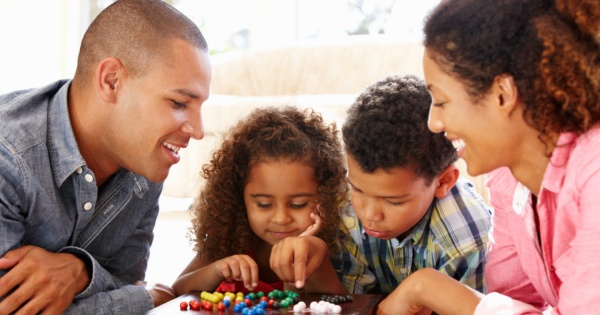 family playing a board game under a warm roof conservatory by Projects 4 Roofing 2