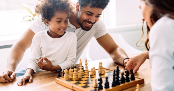 family playing chess under a warm roof conservatory by Projects 4 Roofing 2