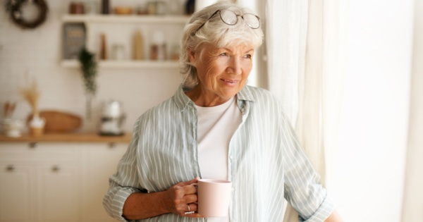 Mature woman thinking about conservatory roofing options