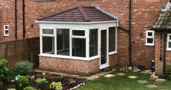 A small conservatory with a solid conservatory roof