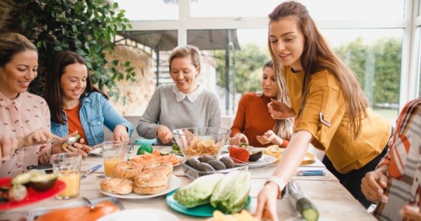 Group of friends preparing lunch while discussing about conservatory roof styles 2