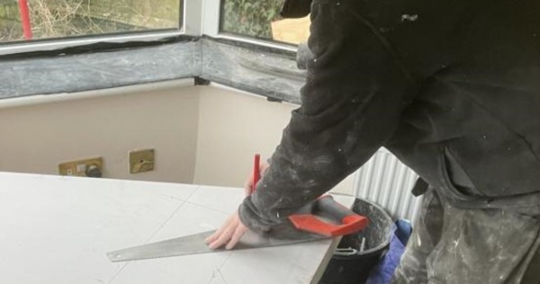 Conservatory roofing installer making measurements 2