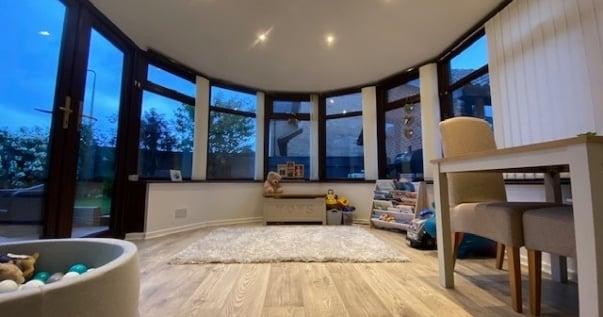 Family undergoes a conservatory conversion and joins their playroom and living room.