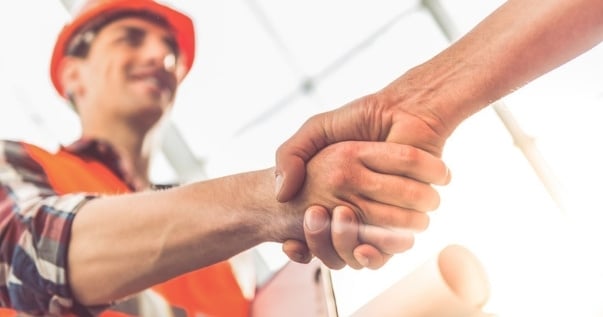 A trustworthy installer shaking hands with the owner of a new guardian warm roof.