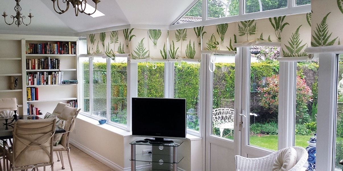 Beautiful transformed conservatory with a garden view that allows for natural light to come in