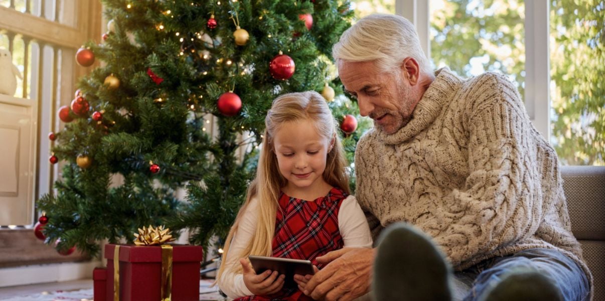 Grandfather and grandaughter enjoying some quality time on Christmas day in an insulated conservatory