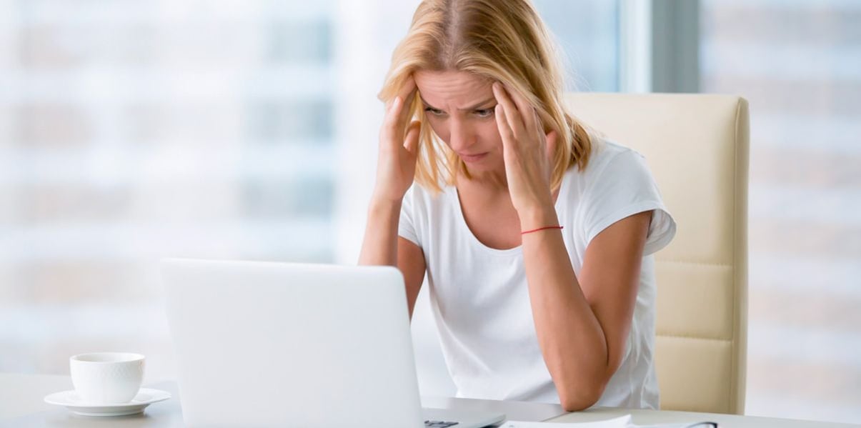Frustrated blond woman unable to work due to the loud noise in her conservatory
