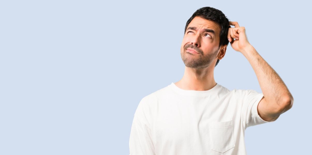 Middleaged man thinking about what would be the best material to replace his conservatory roof with