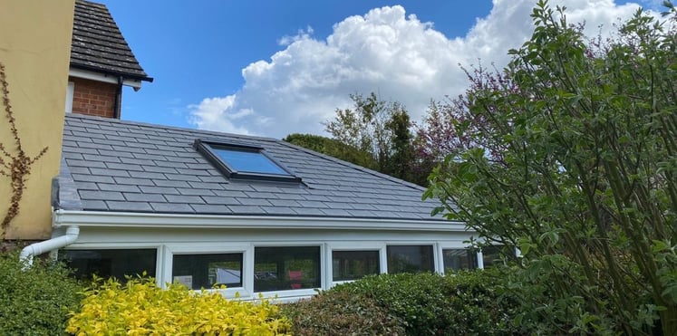 Beautiful and soundproof conservatory with a solid roof, surrounded by plants