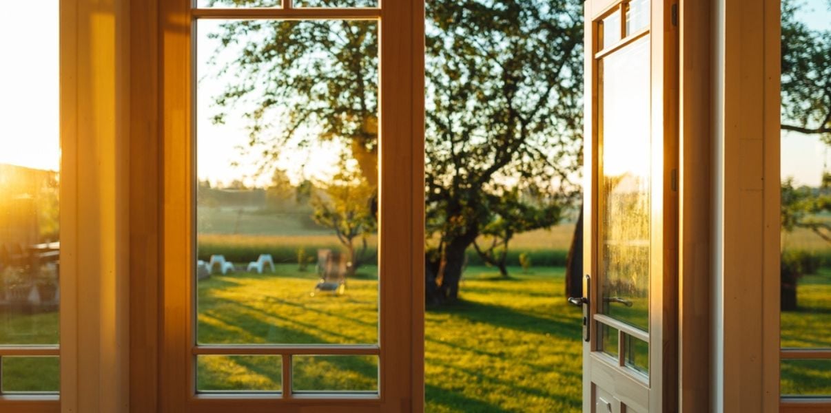 Beautiful garden seen from the inside of a solid roof conservatory