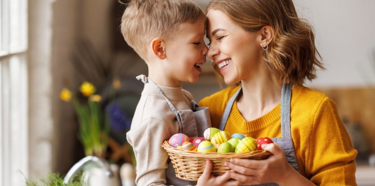 Mother and son hugging an Easter basket in their solid roof conservatory