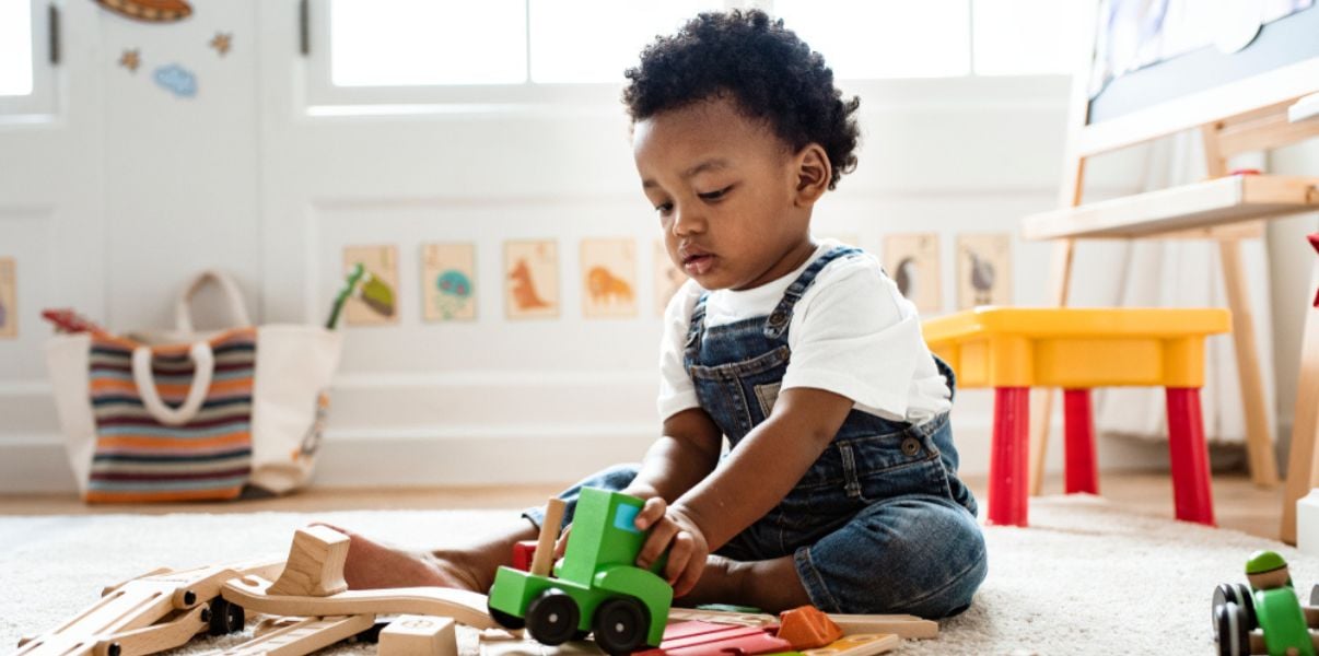 Cute baby boy playing in a lovely solid roof conservatory playroom