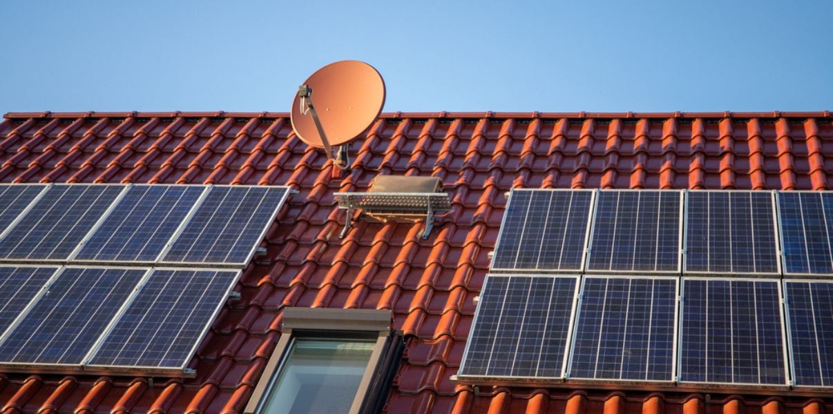 Red-tiled roof with black solar panels