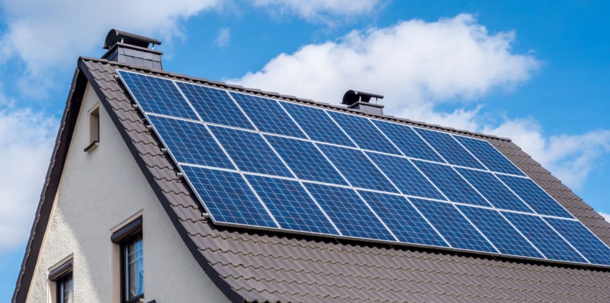 Gray tiled roof with solar panels installed on it