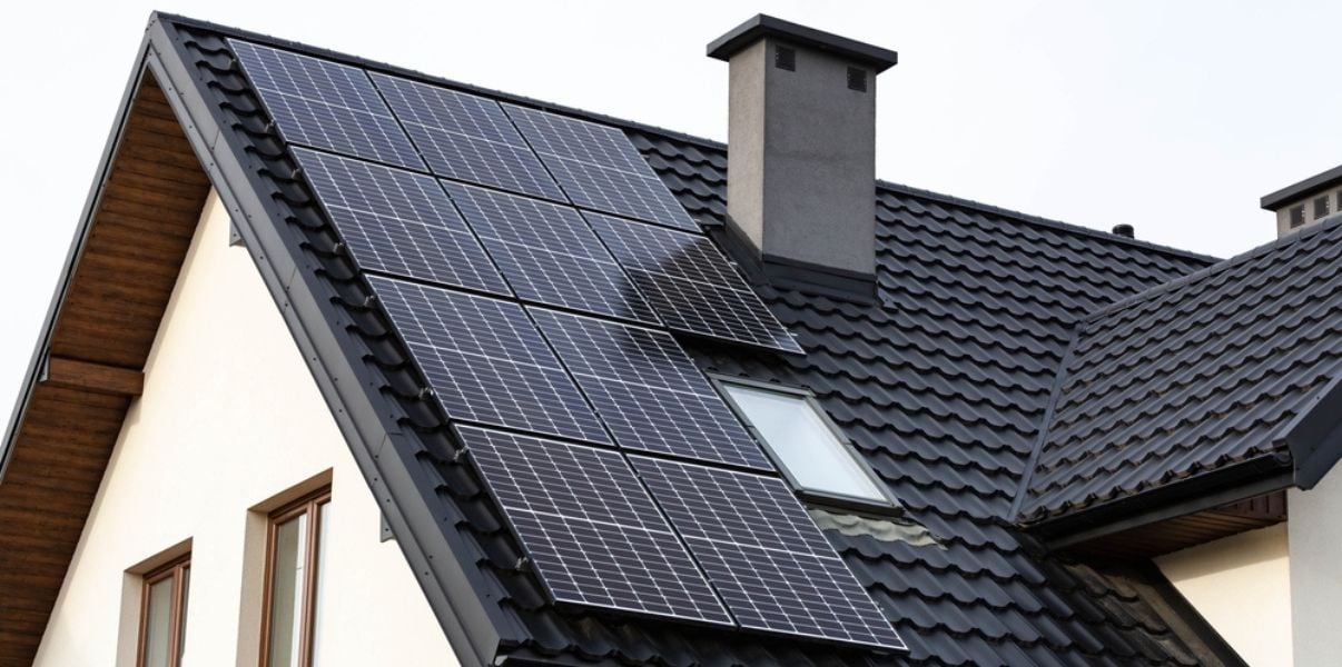 Brand new solar panel system installed on black tiled roof