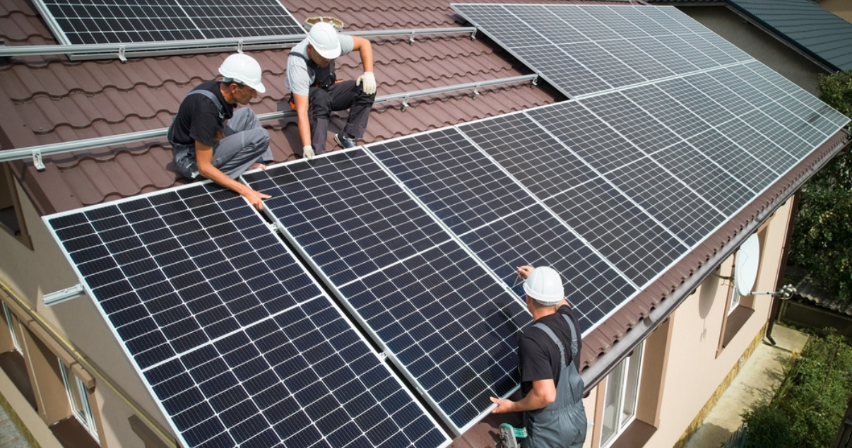 Solar panel workers installing solar panels