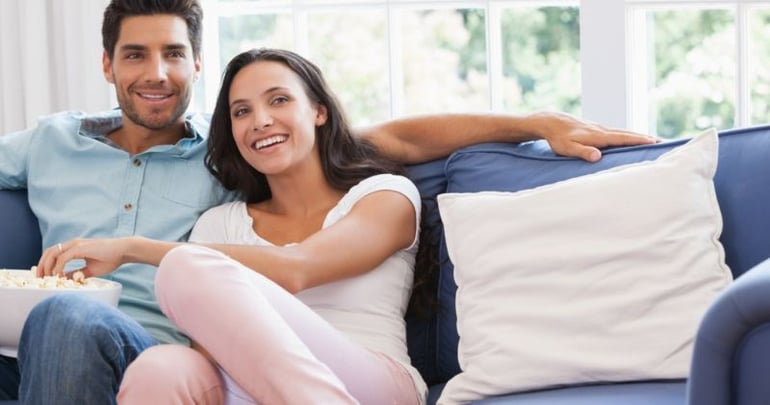 Couple using their newly insulated conservatory to spend time together
