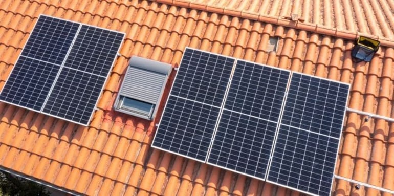 Eco friendly black solar panels installed on a houses roof 