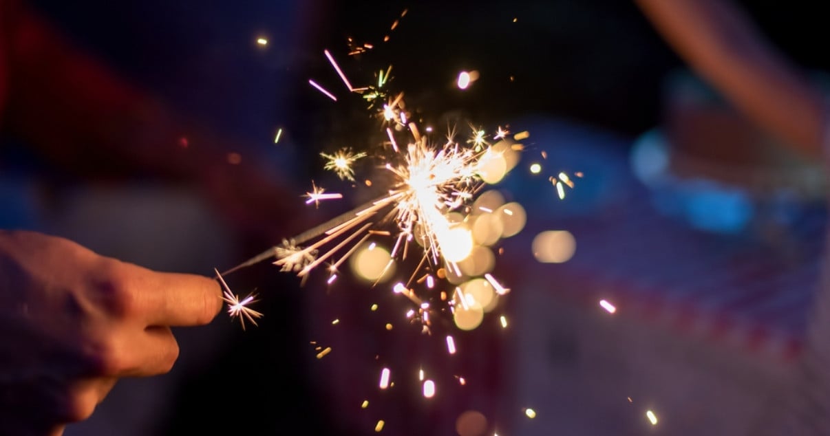 Family playing with a sparkler outside of their converted conservatory 