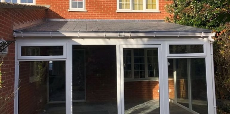 Finished conservatory roof replacement project on a sunny day