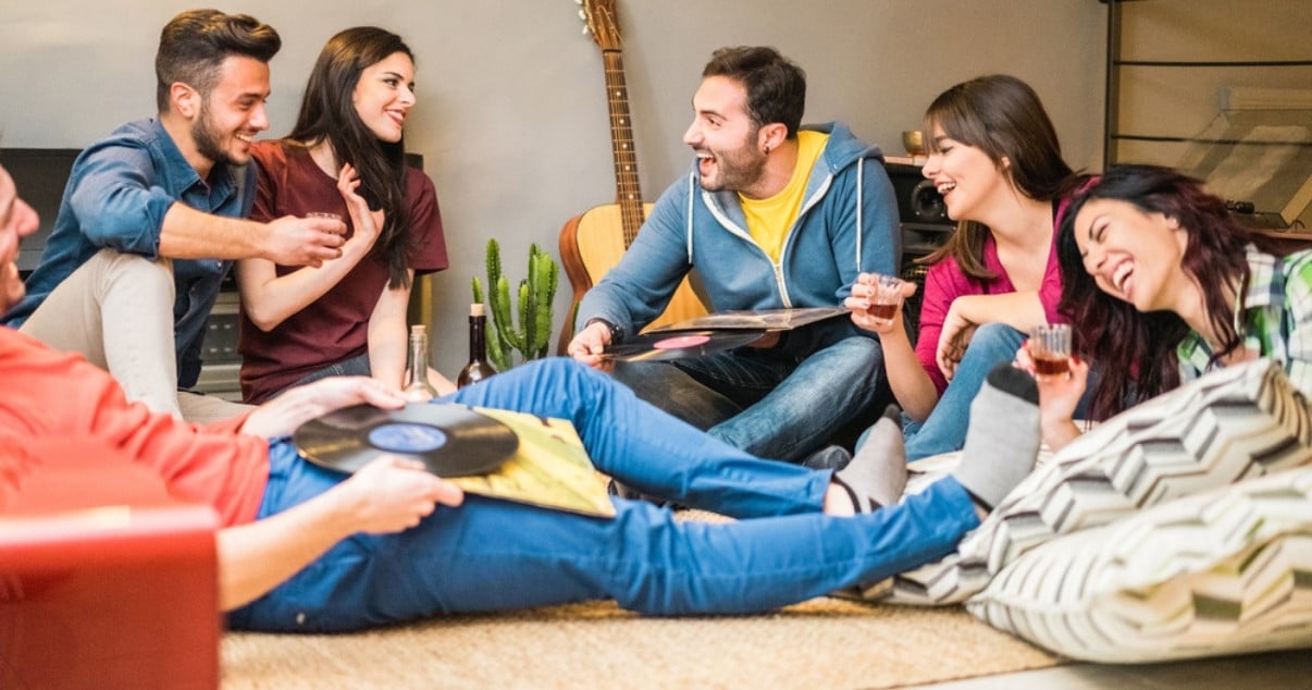 Friends sharing time around in their converted conservatory