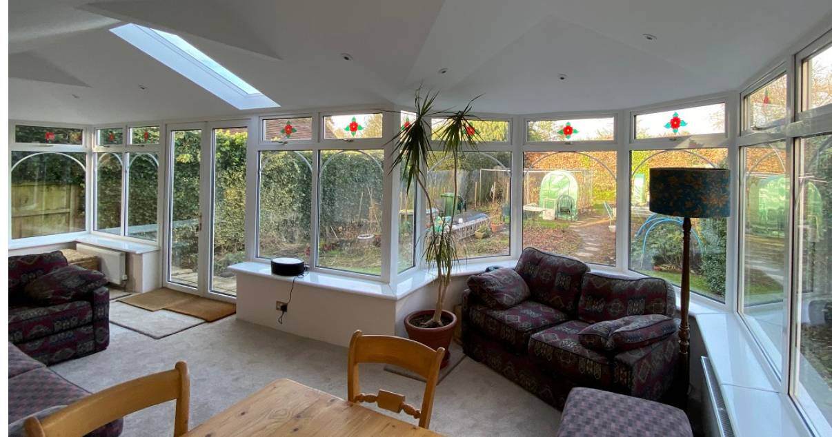 comfortable dinning and living area after warm conservatory transformation 