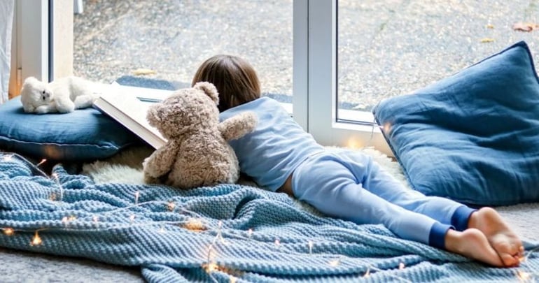 Little kid reading in his conservatory after having a conservatory transformation-1
