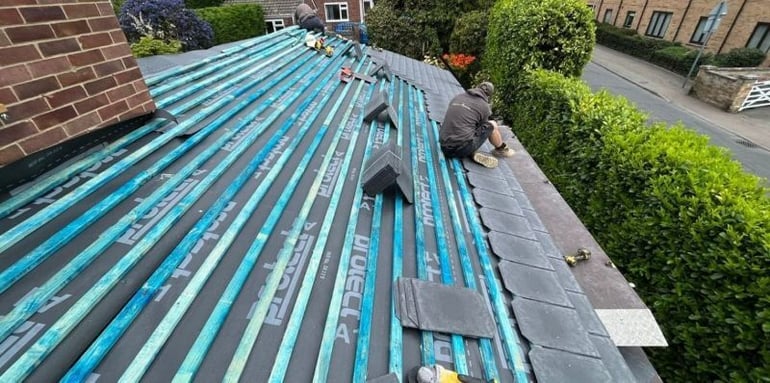 P4R team member installing tiles on an insulated conservatory